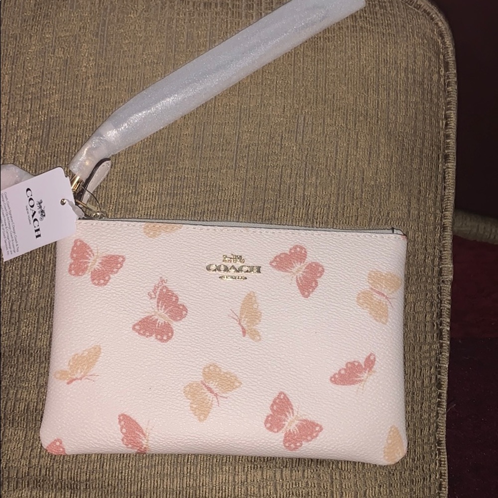 ❤️ON HOLD❤️Coach wristlet with butterfly print